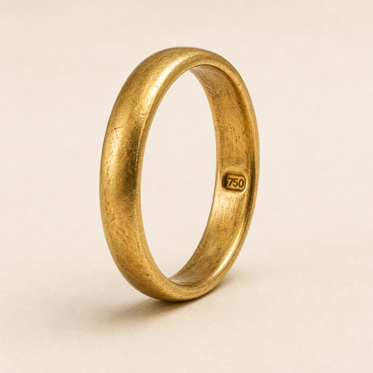 Close-up of hallmark stamps punched into the inner band of a gold ring
